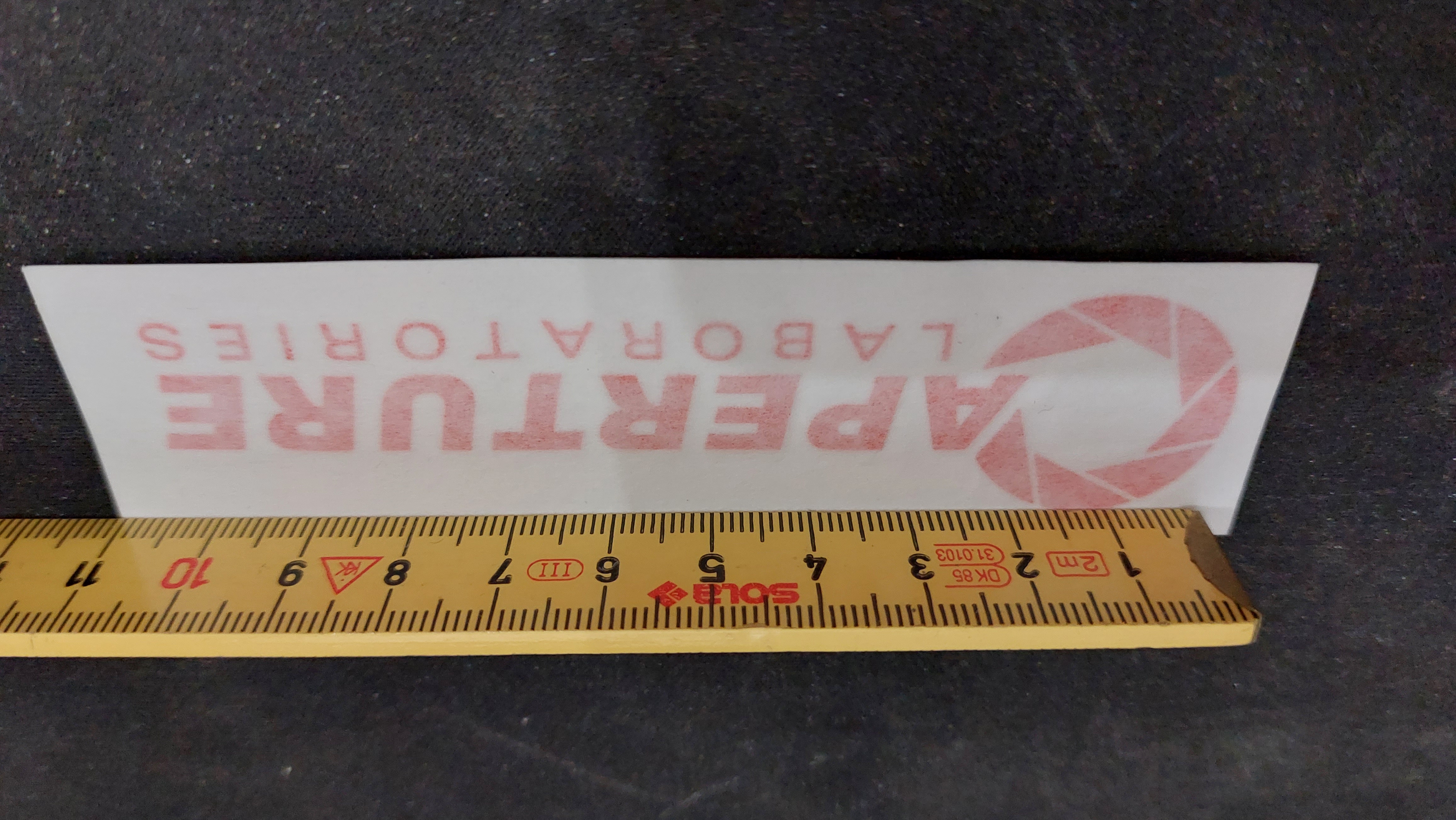 Unapplied logo sticker with centimeter stick but this time to show how long it is