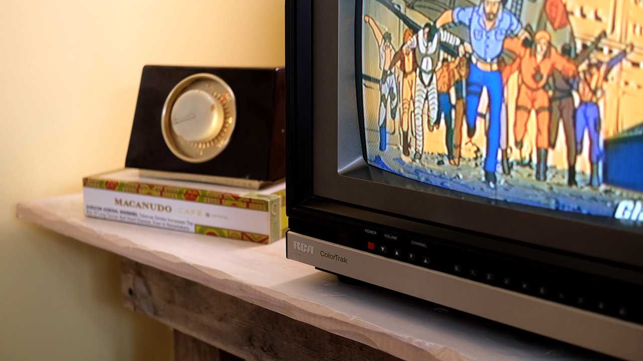 An older TV with an antenna rotator box in the background