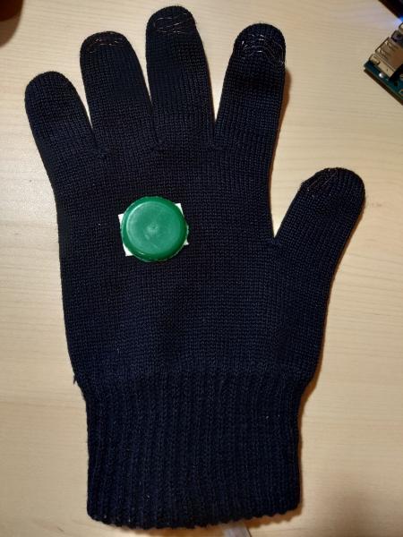 The front side of the glove with visible sensors and tracker target.