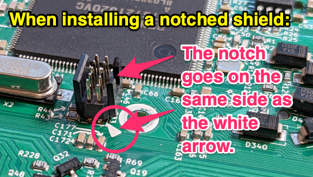 Soldered-in pins with notched shield